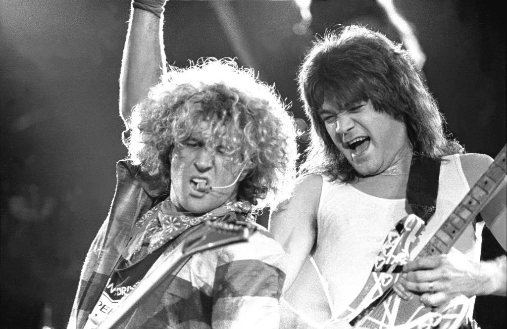 Guitarist Eddie Van Halen and Sammy Hagar are shown performing on stage during a